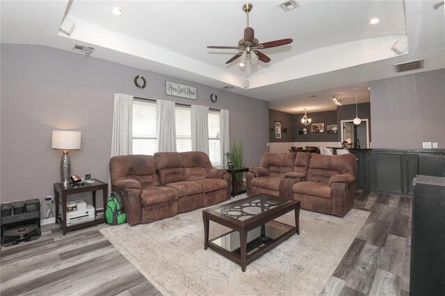717 Vickery Ave, Yukon, OK 73099 - living area featuring a tray ceiling, wood finished floors, a ceiling fan, and recessed lighting