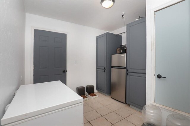 717 Vickery Ave, Yukon, OK 73099 - kitchen with freestanding refrigerator, fridge, light tile patterned floors, gray cabinetry, and light countertops