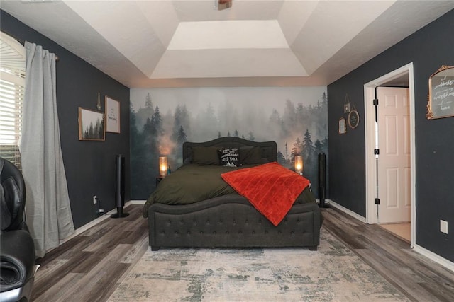 717 Vickery Ave, Yukon, OK 73099 - bedroom featuring a raised ceiling, wood finished floors, and baseboards
