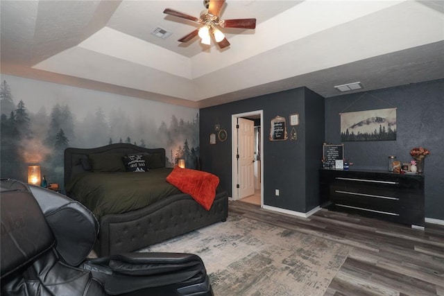 717 Vickery Ave, Yukon, OK 73099 - bedroom with baseboards, a tray ceiling, wood finished floors, and ceiling fan