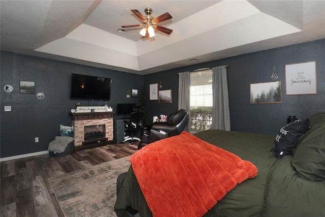 717 Vickery Ave, Yukon, OK 73099 - bedroom featuring a tray ceiling and wood finished floors