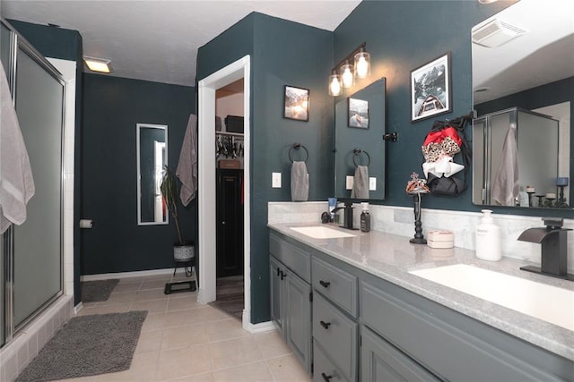 717 Vickery Ave, Yukon, OK 73099 - full bathroom featuring a shower stall, tile patterned flooring, double vanity, and baseboards