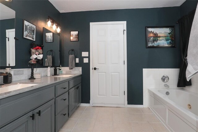 717 Vickery Ave, Yukon, OK 73099 - bathroom with tile patterned floors, a bath, baseboards, and double vanity
