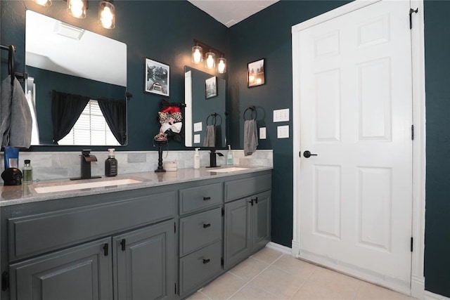 717 Vickery Ave, Yukon, OK 73099 - bathroom featuring tile patterned flooring, double vanity, and baseboards