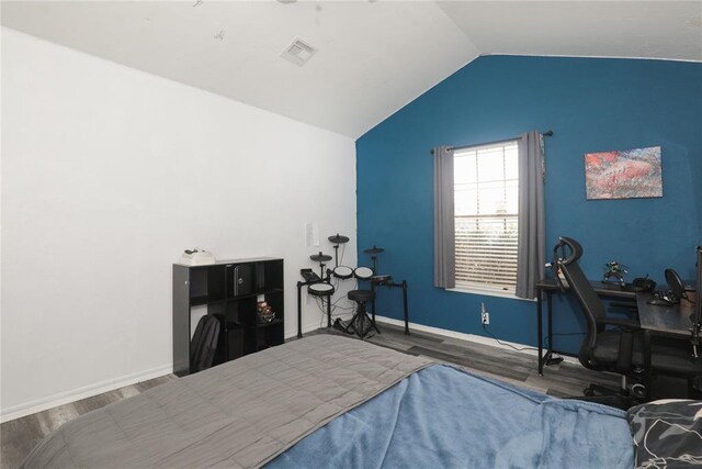 717 Vickery Ave, Yukon, OK 73099 - bedroom featuring wood finished floors, vaulted ceiling, baseboards, and a desk
