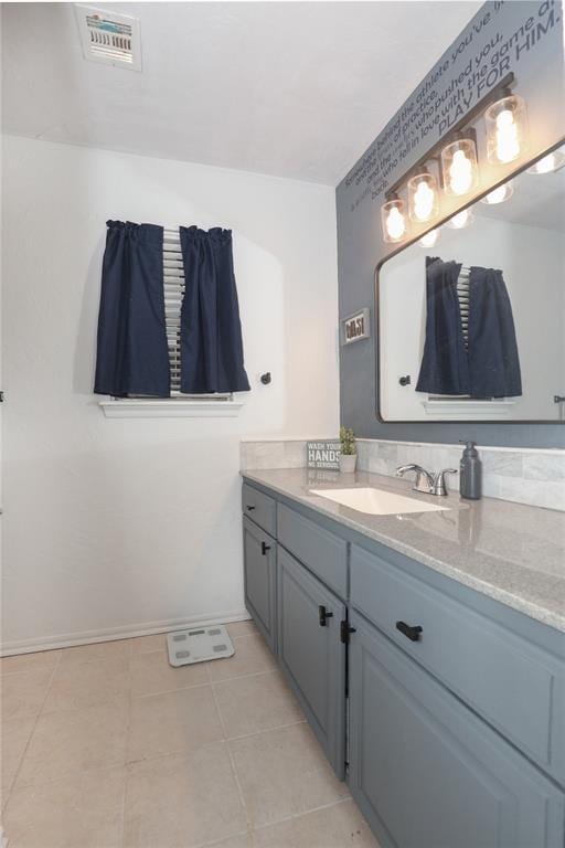 717 Vickery Ave, Yukon, OK 73099 - bathroom featuring baseboards, vanity, and tile patterned floors