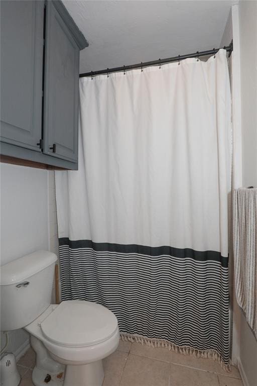 717 Vickery Ave, Yukon, OK 73099 - bathroom featuring tile patterned flooring, toilet, and curtained shower