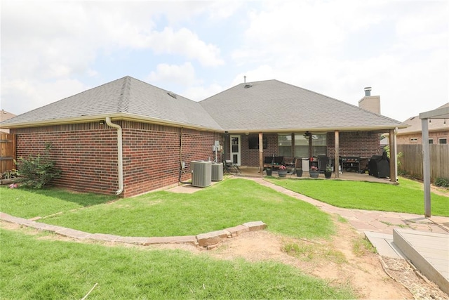 717 Vickery Ave, Yukon, OK 73099 - rear view of house with brick siding, a patio, a chimney, and cooling unit