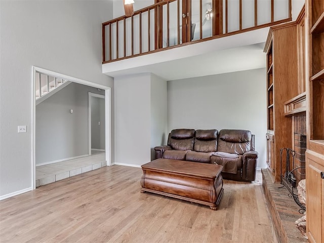 2101 NE 11th St, Moore, OK 73160 - living room featuring a towering ceiling, wood finished floors, baseboards, and stairs