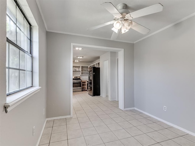 2101 NE 11th St, Moore, OK 73160 - empty room with crown molding, baseboards, light tile patterned flooring, and a ceiling fan