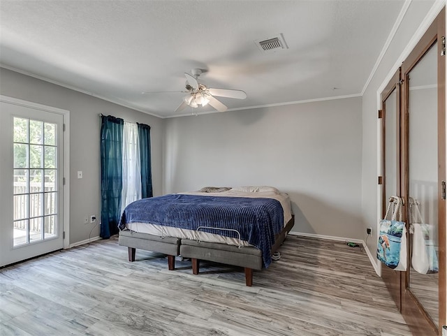 2101 NE 11th St, Moore, OK 73160 - bedroom featuring baseboards, light wood-type flooring, ornamental molding, a ceiling fan, and access to exterior