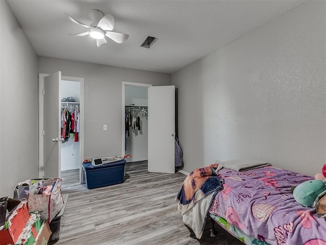 2101 NE 11th St, Moore, OK 73160 - bedroom featuring a spacious closet, light wood-style flooring, a closet, and ceiling fan
