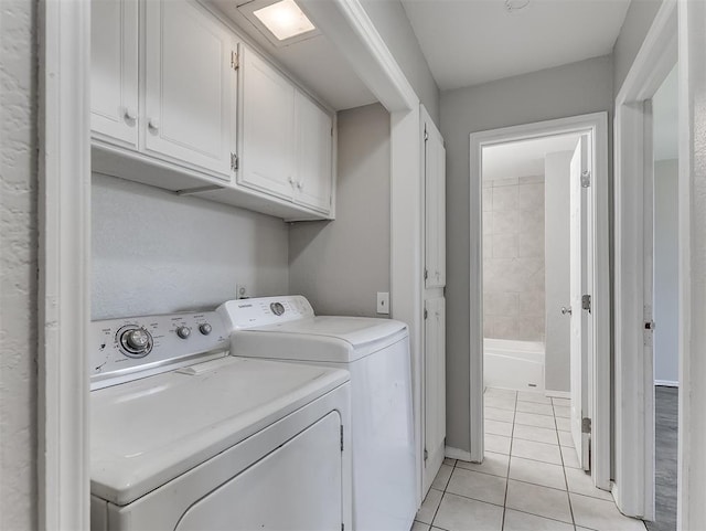 2101 NE 11th St, Moore, OK 73160 - laundry room with independent washer and dryer, light tile patterned flooring, and cabinet space