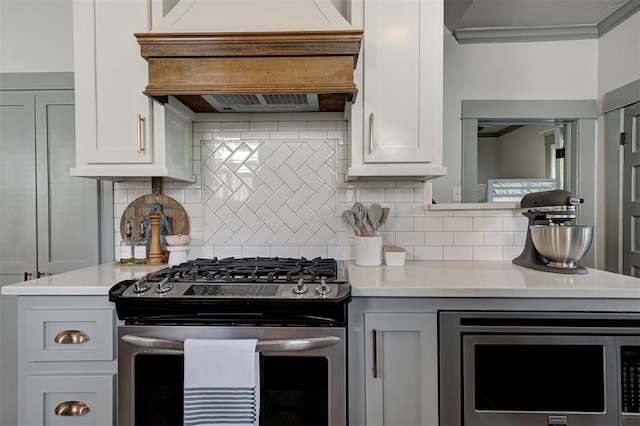 704 NW 20th St, Oklahoma City, OK 73103 - kitchen featuring appliances with stainless steel finishes, custom exhaust hood, light countertops, ornamental molding, and tasteful backsplash