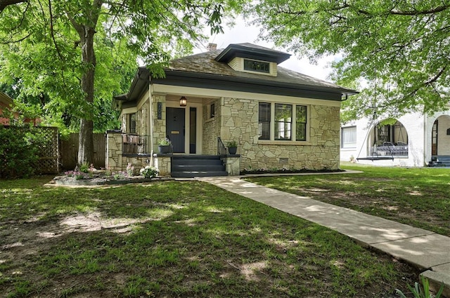 704 NW 20th St, Oklahoma City, OK 73103 - bungalow-style house featuring stone siding, covered porch, and a chimney