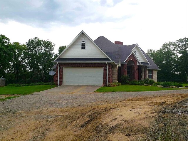 7336 E 136th Rd, Holdenville, OK 74848 - traditional home featuring driveway, brick siding, a chimney, and a front lawn