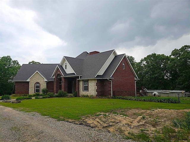 7336 E 136th Rd, Holdenville, OK 74848 - view of front of house featuring a chimney, brick siding, a front lawn, stone siding, and roof with shingles
