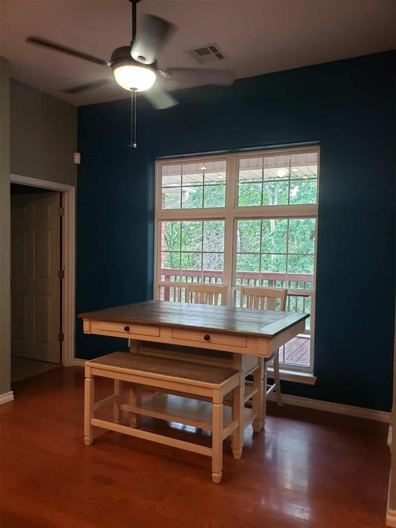 7336 E 136th Rd, Holdenville, OK 74848 - dining space with ceiling fan, wood finished floors, plenty of natural light, and baseboards