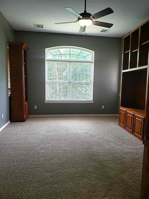 7336 E 136th Rd, Holdenville, OK 74848 - carpeted empty room with a ceiling fan and baseboards