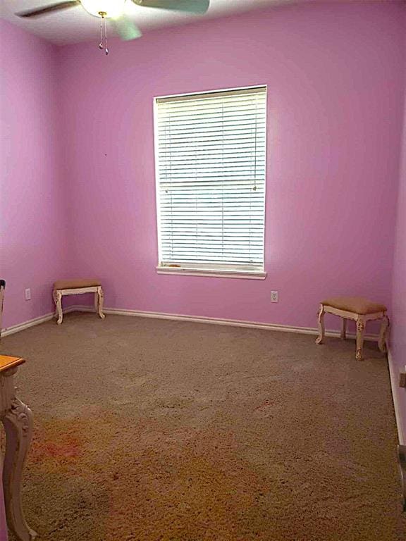 7336 E 136th Rd, Holdenville, OK 74848 - carpeted spare room featuring ceiling fan and baseboards
