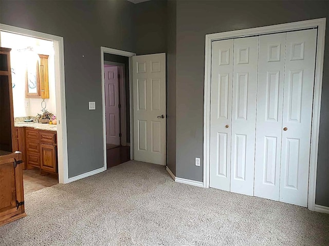 7336 E 136th Rd, Holdenville, OK 74848 - bedroom featuring light colored carpet, baseboards, a closet, and ensuite bath