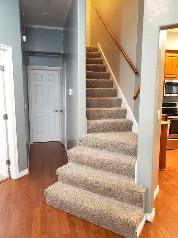 7336 E 136th Rd, Holdenville, OK 74848 - stairs with wood finished floors and baseboards