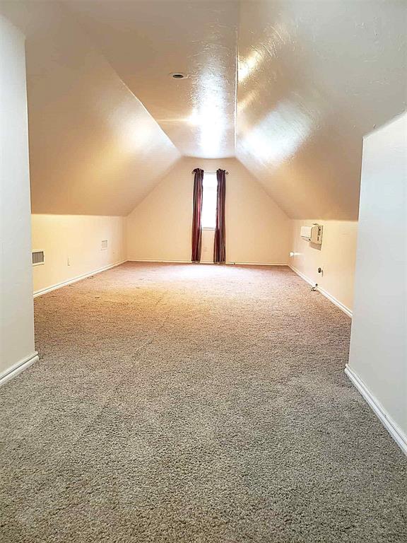 7336 E 136th Rd, Holdenville, OK 74848 - bonus room featuring vaulted ceiling, carpet flooring, and baseboards