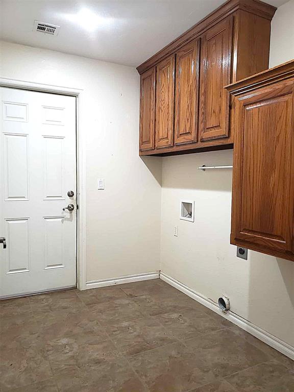 7336 E 136th Rd, Holdenville, OK 74848 - clothes washing area featuring electric dryer hookup, baseboards, hookup for a washing machine, and cabinet space