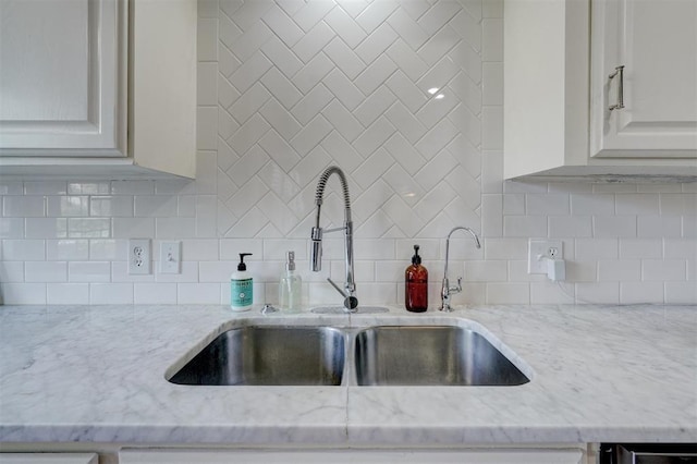 3104 NW 21st St, Oklahoma City, OK 73107 - kitchen with light stone countertops, decorative backsplash, and white cabinetry