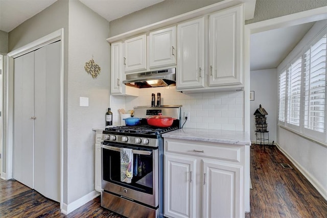 3104 NW 21st St, Oklahoma City, OK 73107 - kitchen featuring stainless steel range with gas stovetop, under cabinet range hood, dark wood finished floors, decorative backsplash, and white cabinetry