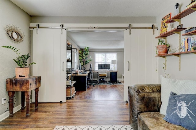 3104 NW 21st St, Oklahoma City, OK 73107 - home office with a barn door and wood finished floors