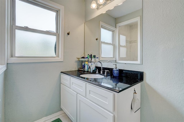 3104 NW 21st St, Oklahoma City, OK 73107 - bathroom with vanity, plenty of natural light, and a textured wall
