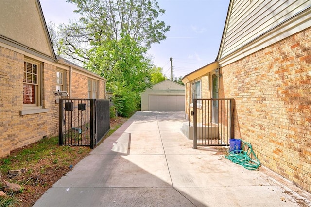 3104 NW 21st St, Oklahoma City, OK 73107 - view of patio with a gate, a detached garage, and an outdoor structure