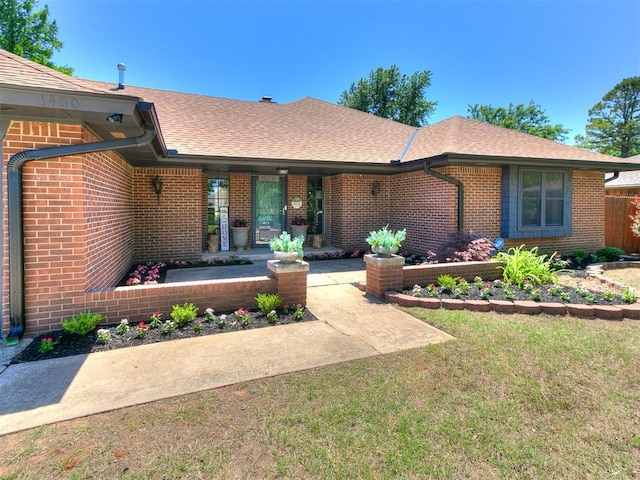 1400 Brookhaven Dr, Edmond, OK 73034 - view of front facade featuring brick siding, a shingled roof, a front yard, and a porch
