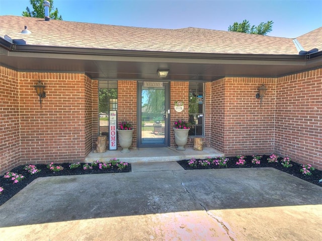 1400 Brookhaven Dr, Edmond, OK 73034 - property entrance with brick siding and roof with shingles