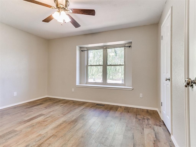 1400 Brookhaven Dr, Edmond, OK 73034 - empty room with wood finished floors, baseboards, and a ceiling fan