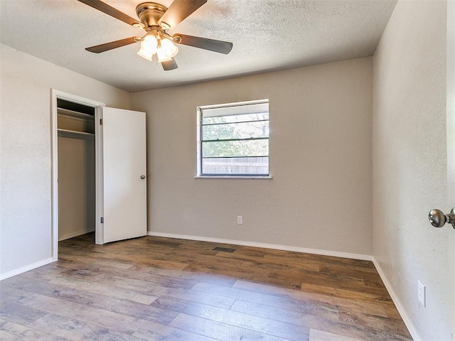 1400 Brookhaven Dr, Edmond, OK 73034 - unfurnished bedroom with wood finished floors, baseboards, ceiling fan, and a closet