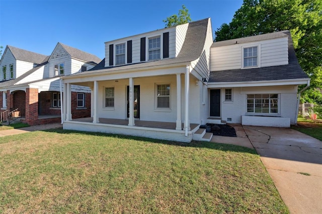 2321 NW 25th St, Oklahoma City, OK 73107 - view of front facade with brick siding, covered porch, a front lawn, and a shingled roof
