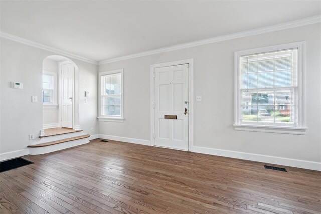 2321 NW 25th St, Oklahoma City, OK 73107 - foyer with arched walkways, hardwood / wood-style floors, crown molding, and baseboards