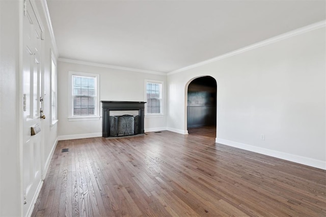 2321 NW 25th St, Oklahoma City, OK 73107 - unfurnished living room with arched walkways, hardwood / wood-style flooring, a fireplace with flush hearth, crown molding, and baseboards