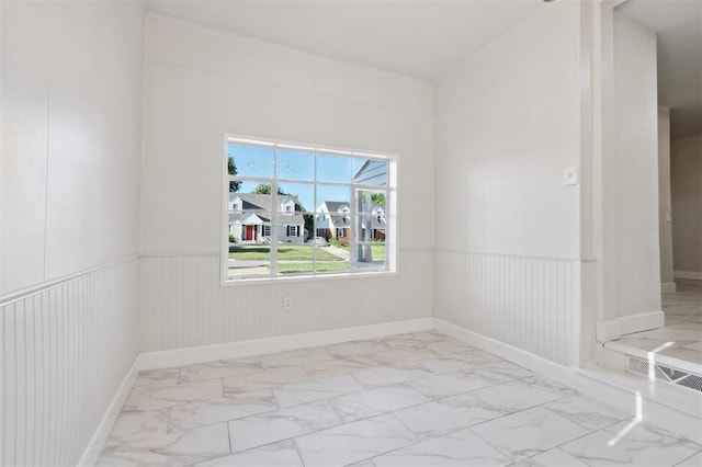 2321 NW 25th St, Oklahoma City, OK 73107 - spare room with marble finish floors and wainscoting