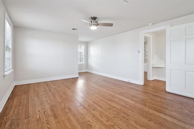 2321 NW 25th St, Oklahoma City, OK 73107 - empty room featuring light wood-type flooring, a ceiling fan, and baseboards