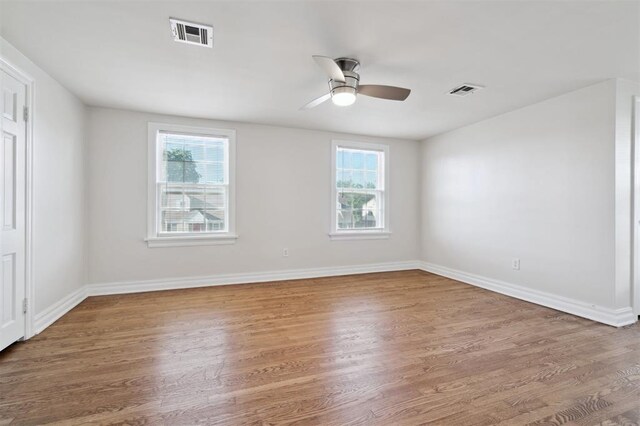 2321 NW 25th St, Oklahoma City, OK 73107 - spare room with healthy amount of natural light, wood finished floors, ceiling fan, and baseboards