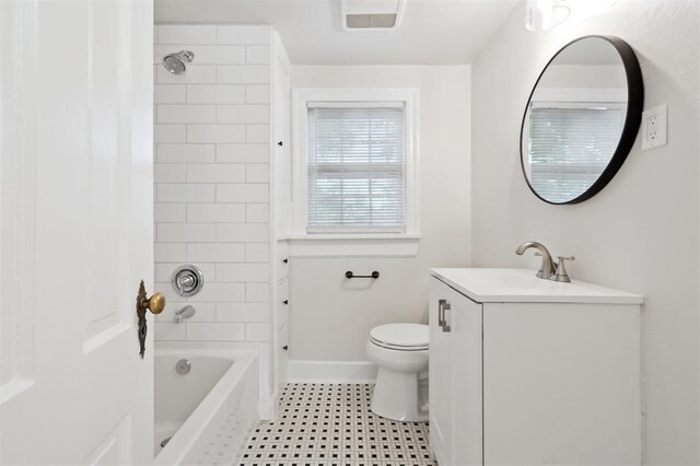 2321 NW 25th St, Oklahoma City, OK 73107 - bathroom featuring toilet, baseboards, vanity, and shower / washtub combination