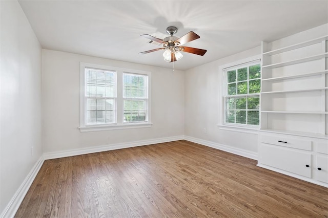 2321 NW 25th St, Oklahoma City, OK 73107 - unfurnished room featuring baseboards, ceiling fan, and wood finished floors