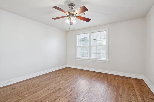 2321 NW 25th St, Oklahoma City, OK 73107 - spare room with baseboards, wood finished floors, and a ceiling fan
