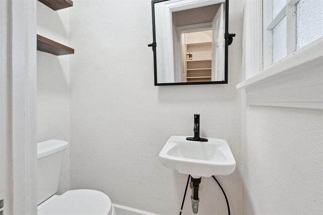 2321 NW 25th St, Oklahoma City, OK 73107 - bathroom featuring toilet and baseboards