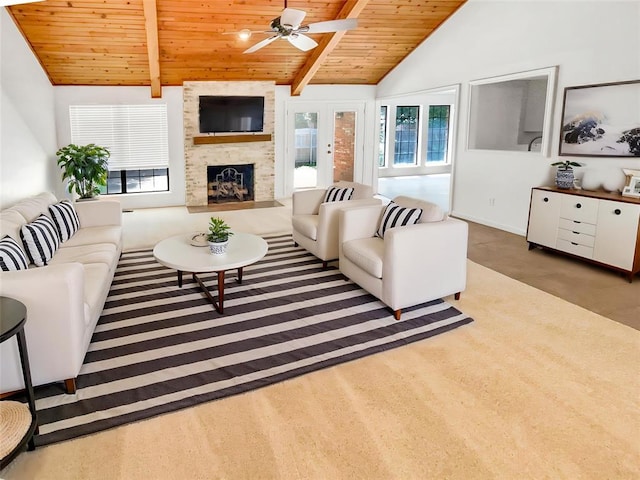 living area featuring wooden ceiling, plenty of natural light, ceiling fan, a fireplace, and baseboards