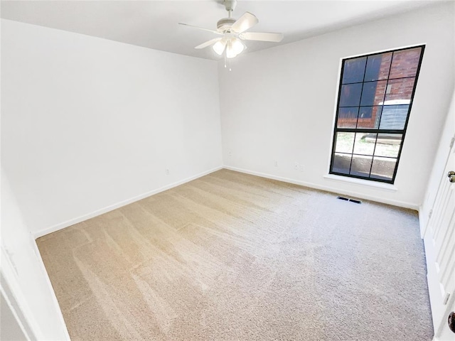 unfurnished room with ceiling fan, carpet flooring, and baseboards