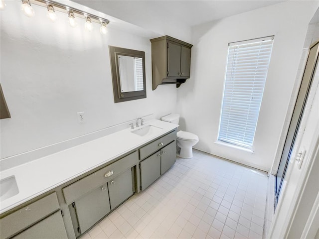 full bath with toilet, tile patterned flooring, vanity, and a shower with door